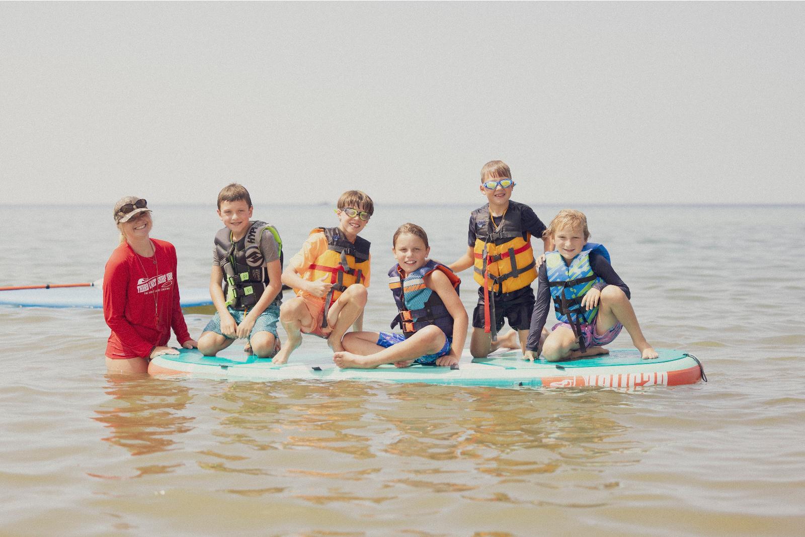 Fun on the paddleboard at beach day camp